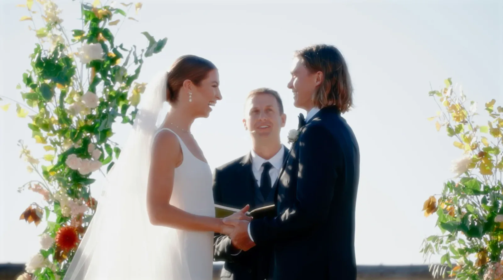 Couple exchanging wedding vows before an officiant